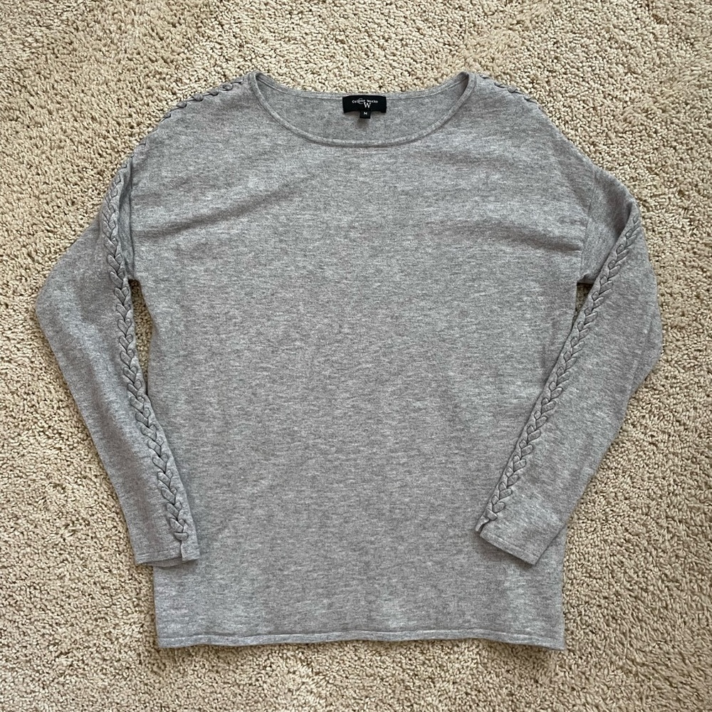 Color Works grey sweater in size M with braided detail on shoulders and arms.
